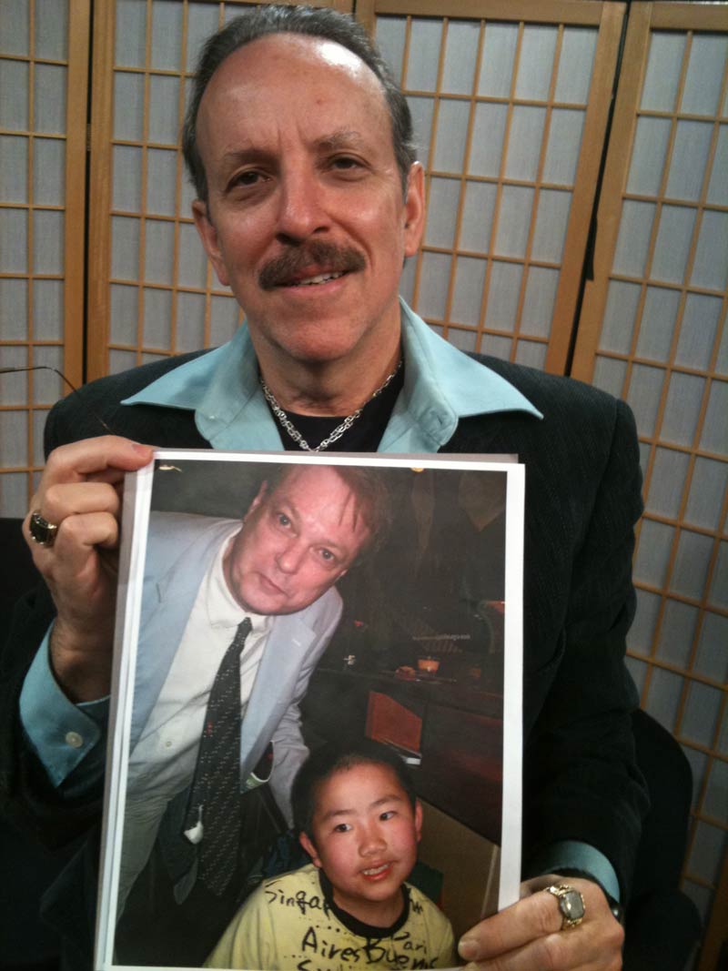 Jud Newborn holding a photo of Bill Plympton and Perry Chen