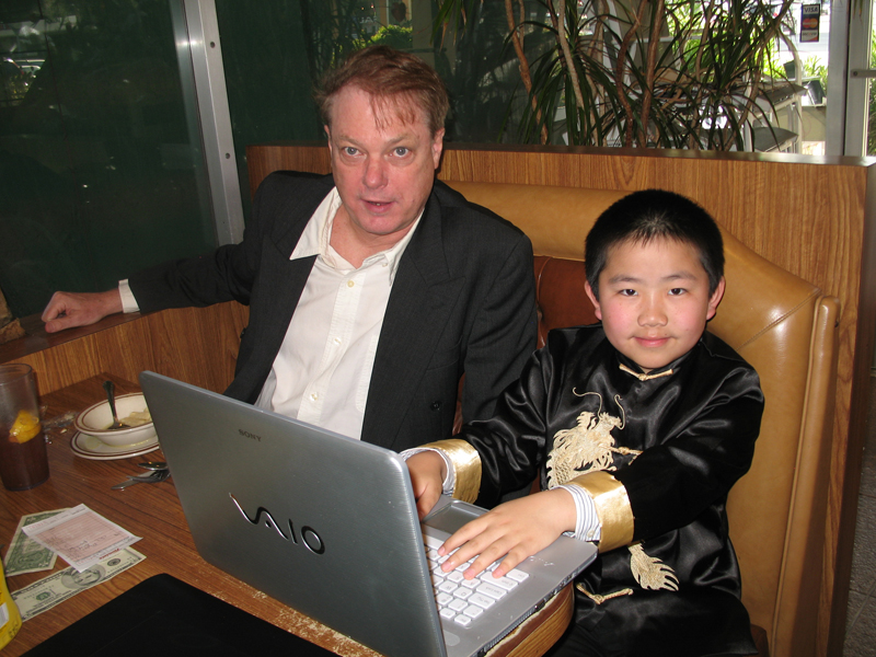 Bill Plympton and Perry Chen sitting in a diner looking at a laptop